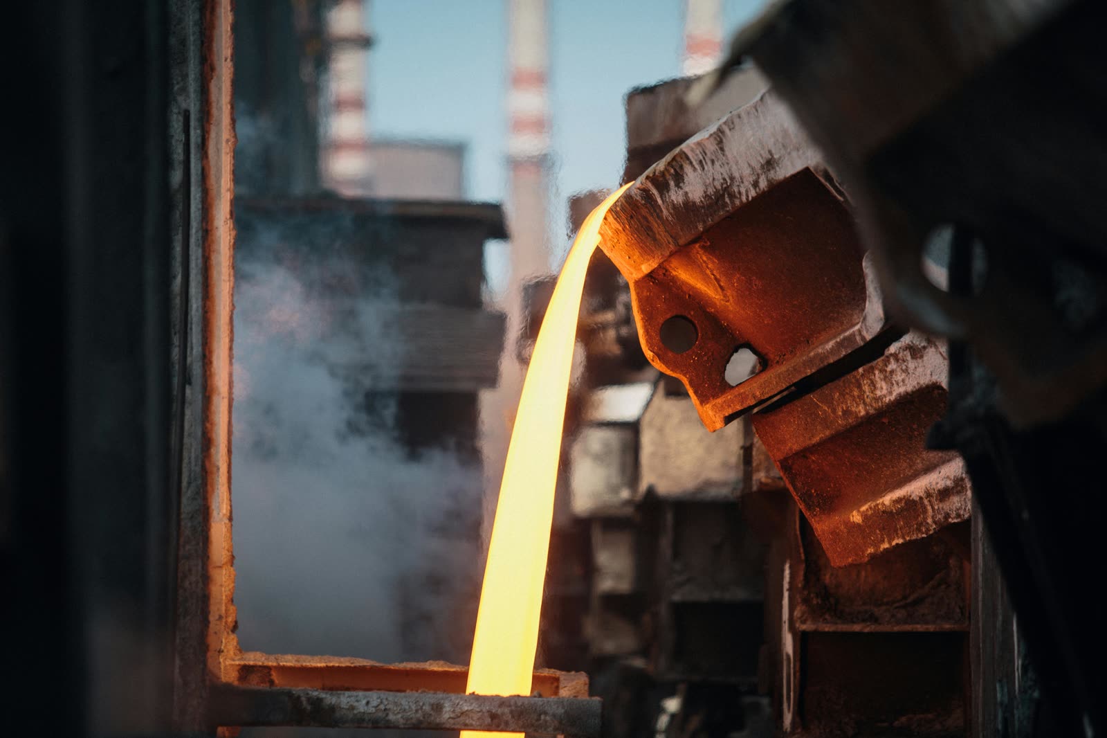 Molten steel pouring over a refractory-lined launder