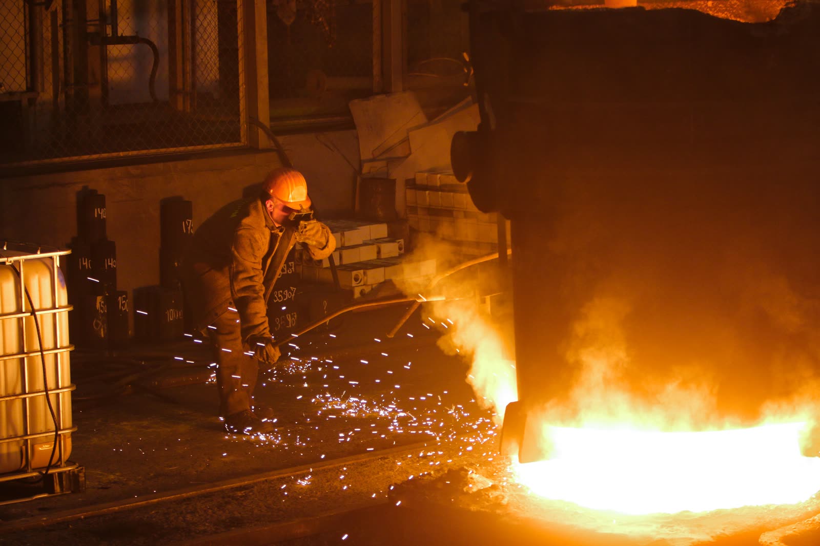 Worker tapping a smelting furnace